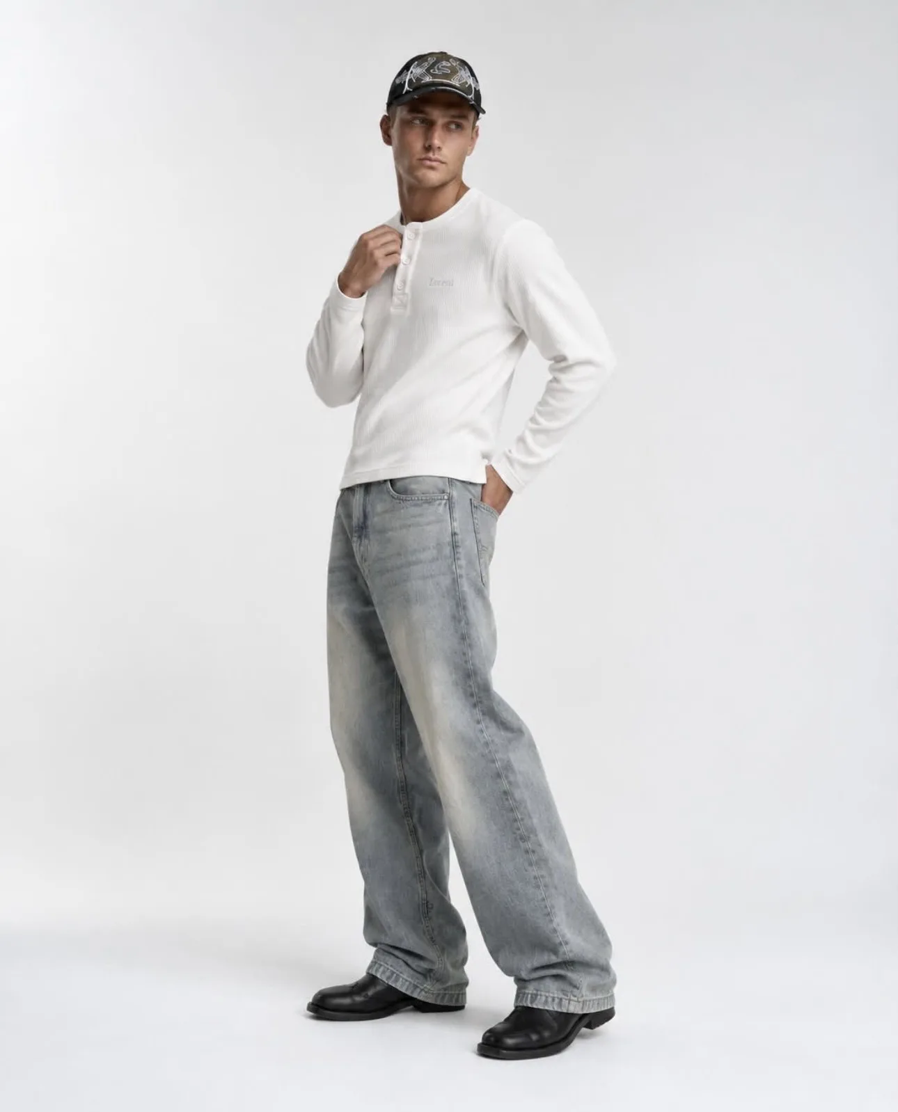 Male model wearing the white Matteo Henley, side pose