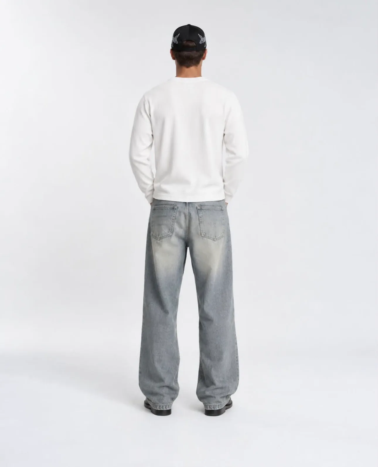 Male model wearing the white Matteo Henley, back view