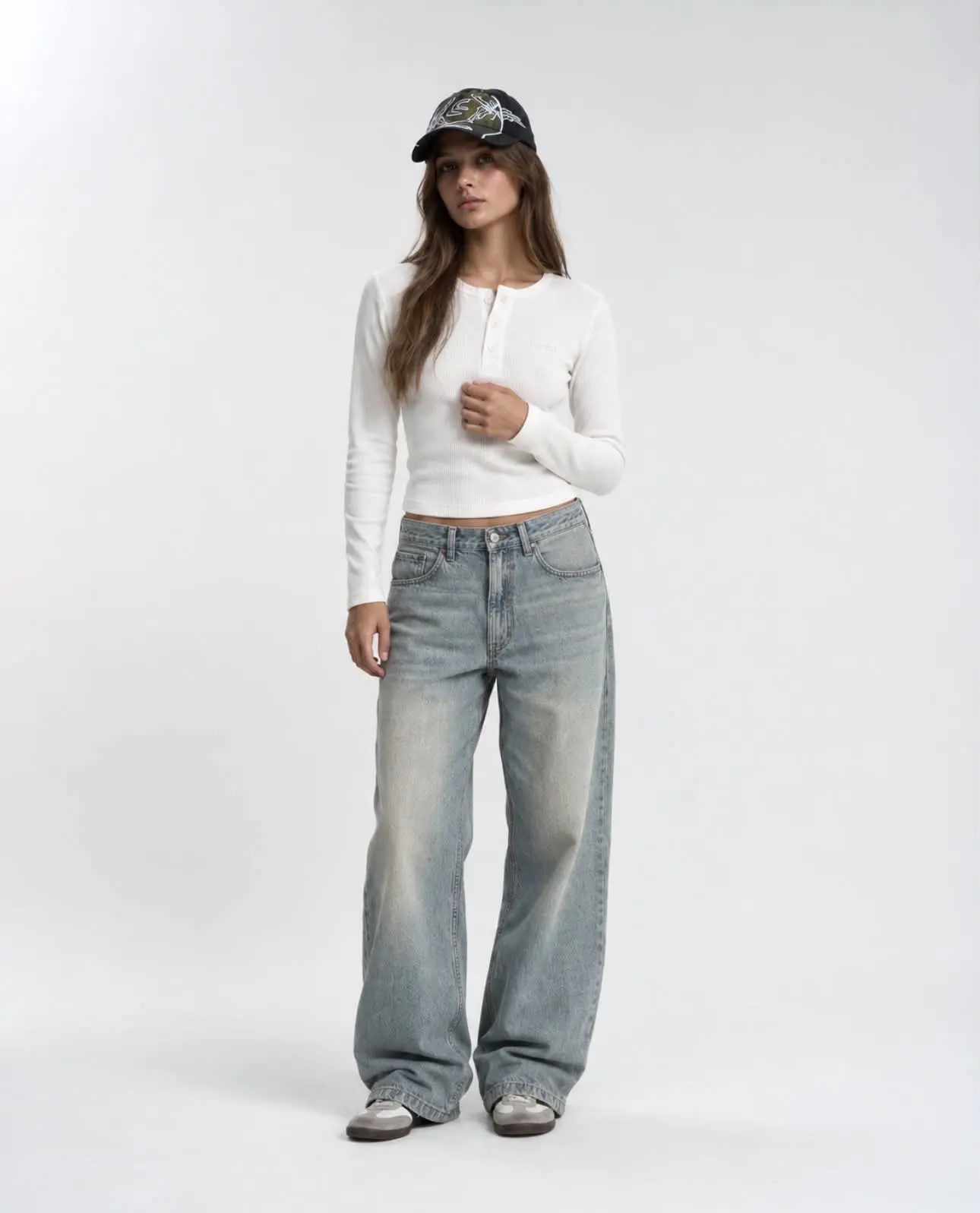 Female model wearing the white Matteo Henley, full-length front view