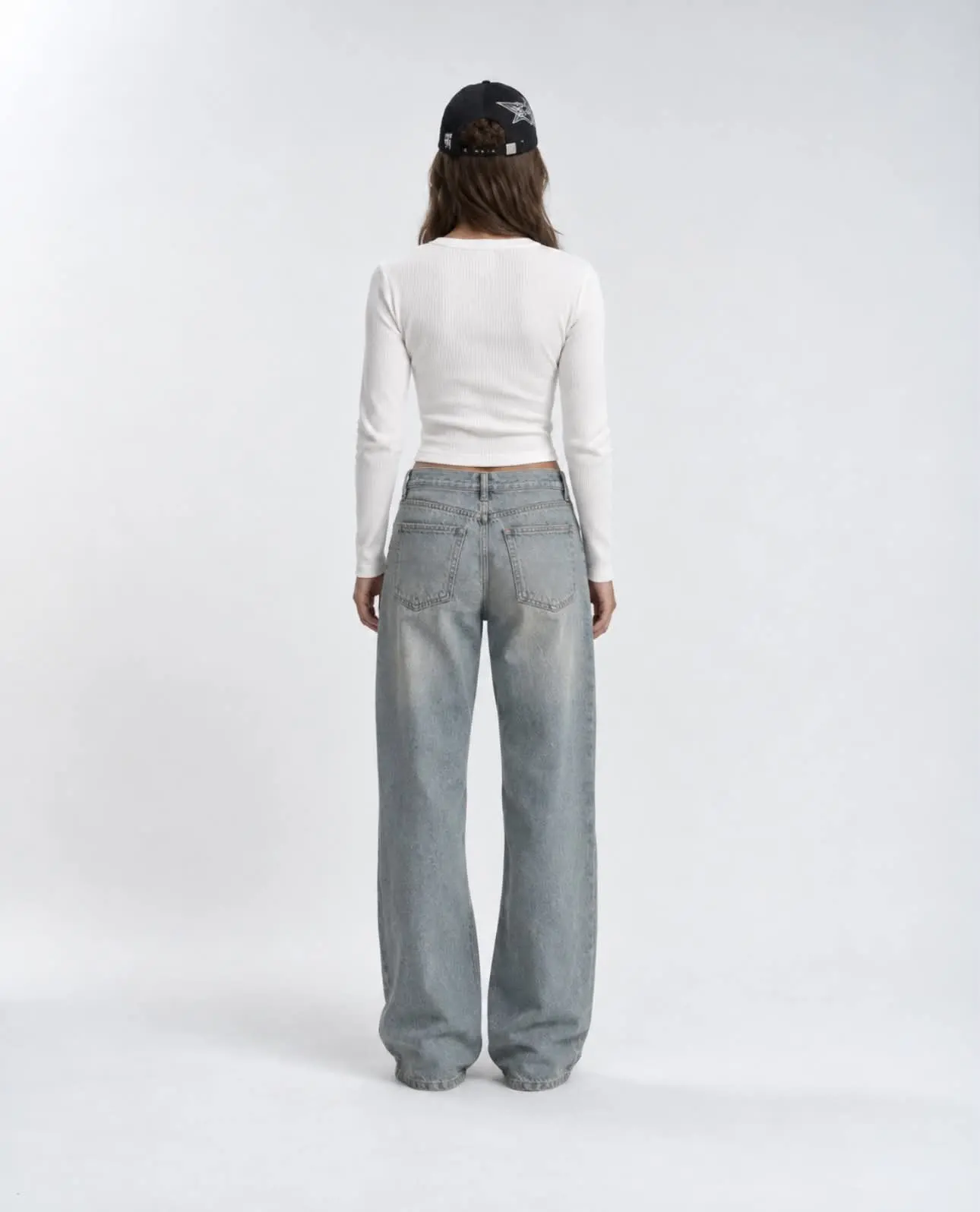 Female model wearing the white Matteo Henley, back and side view